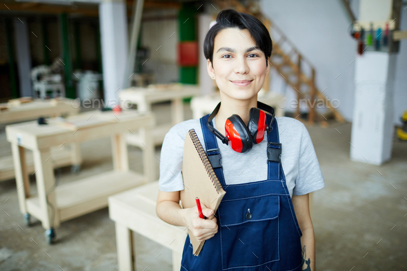 Pretty girl learning about carpentry - Stock Photo - Images