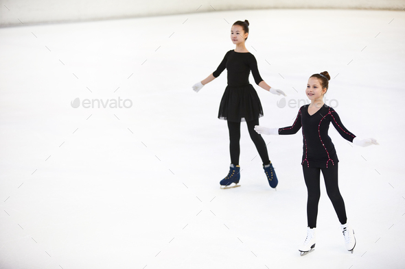 Two Girls Posing on Skating Rink - Stock Photo - Images