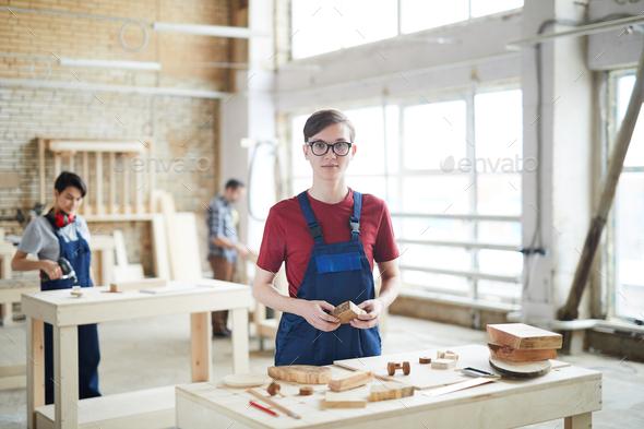 Young carpenter working with wood - Stock Photo - Images
