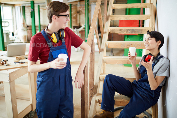Young carpentry workers chatting during break - Stock Photo - Images