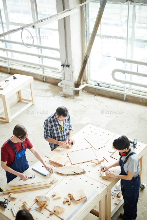 Busy carpenters producing furniture - Stock Photo - Images