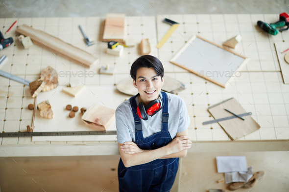 Cheerful lady carpenter in own workshop - Stock Photo - Images