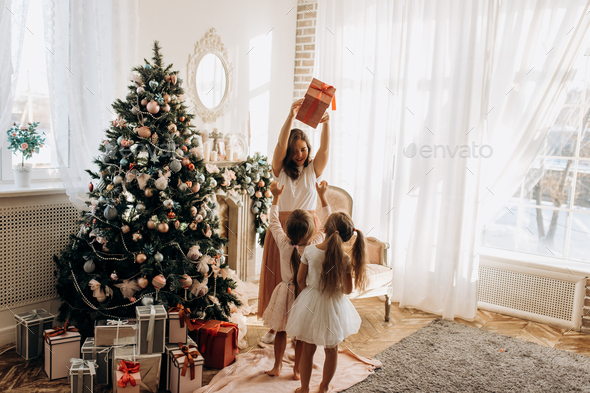 Happy young mother and her two charming daughter in nice dresses - Stock Photo - Images