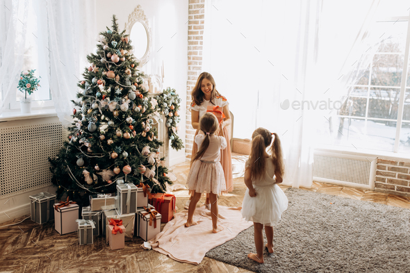 Happy young mother and her two charming daughter in nice dresses - Stock Photo - Images