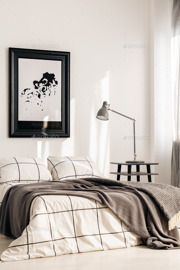 Industrial lamp on nightstand table next to king size bed in white bedroom interior - Stock Photo - Images