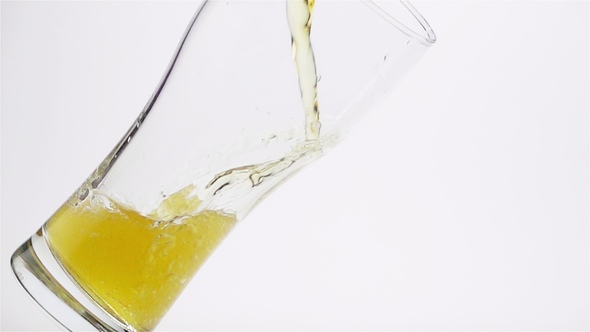Light Beer is Poured into the Glass alt