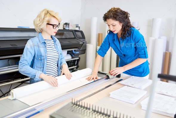 Women Cutting Paper in Printing Shop