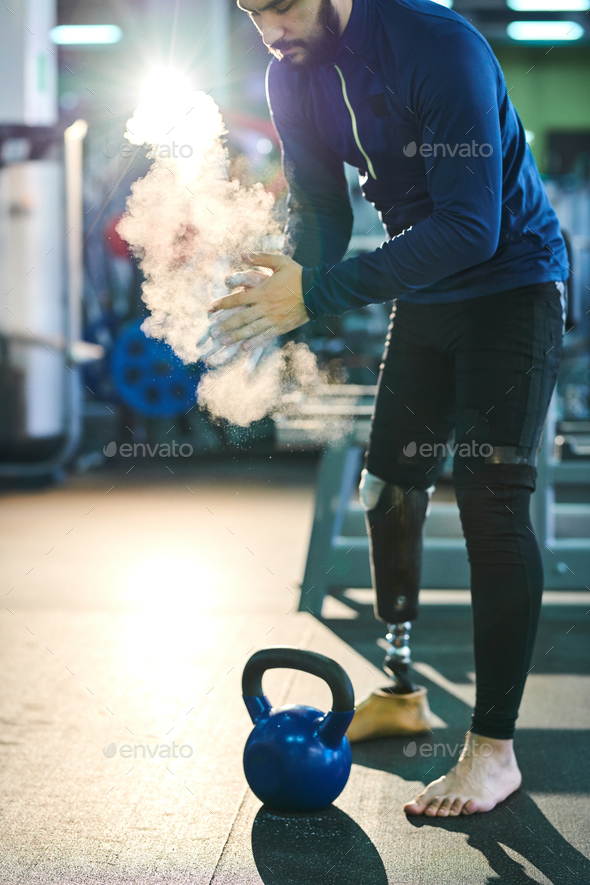 Disabled man preparing for weight training