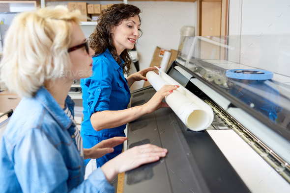 Women Changing Paper in Printing Press