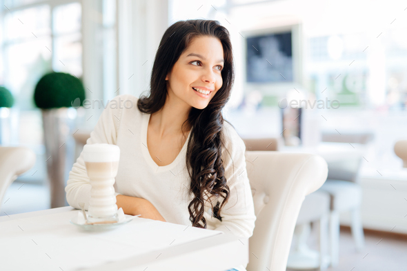 Glamorous lady drinking coffee in a beautiful cafe Stock Photo by nd3000