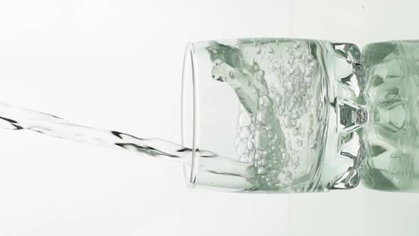 Vertical Video Crystal Clear Water Pouring Into Glass