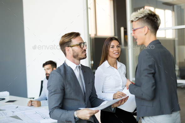 Picture of business colleagues talking in office - Stock Photo - Images