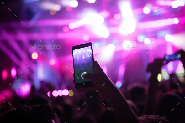 Portrait of happy crowd enjoying at music festival - Stock Photo - Images
