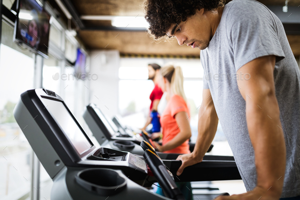 Picture of people running on treadmill in gym - Stock Photo - Images
