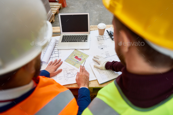 Construction Workers Looking at Plans