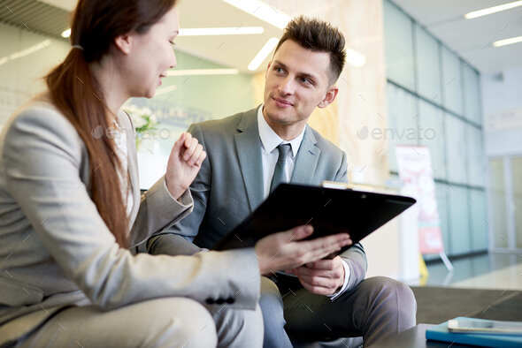 Cheerful Young Colleagues Discussing Business Project - Stock Photo - Images