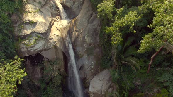Waterfall Flowing From Sheer Rocky Mountains With People Swimming In Yelapa, Jalisco, Mexico. Tilt-d alt