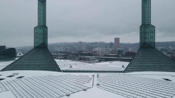 Flying Over Oregon Convention Center in the Winter to Reveal a Snow Covered Downtown Portland alt