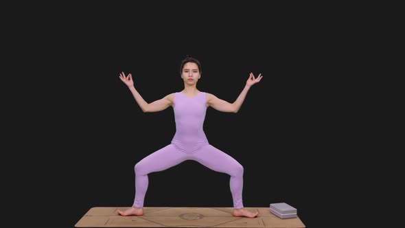 Young Woman Practicing Goddess Pose Doing Yoga, Alpha in