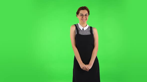 Funny Girl in Round Glasses Is Waving Hand and Showing Gesture Come Here, Flirting. Green Screen alt