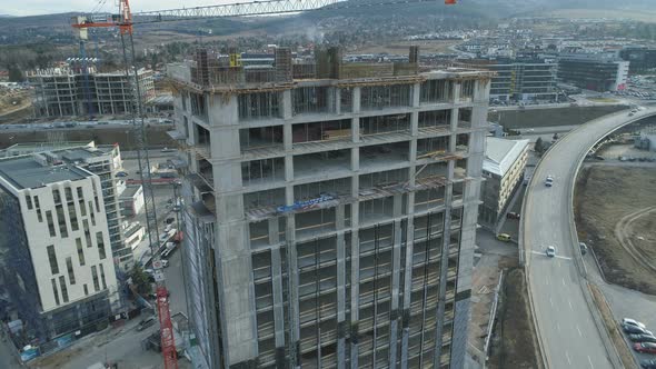 Building Tower Cranes on Construction of Multi Story House or Office Building in Business Park Sofia alt
