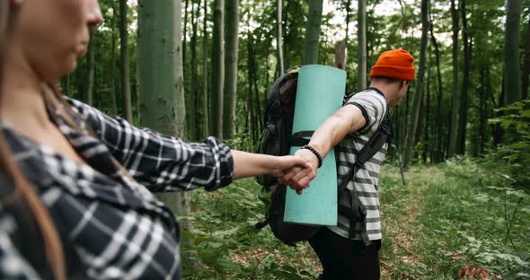 Couple of Tourists Holding Hands in Forest