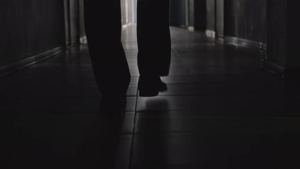 Silhouette of Legs of Businessman Walking at Camera