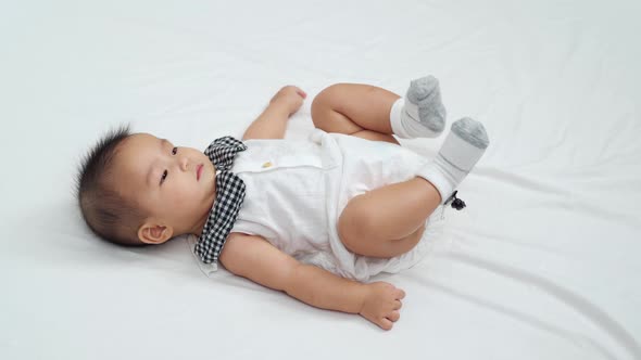 cheerful  baby newborn playing on a bed