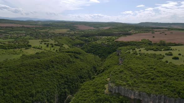 Drone flight over a picturesque river canyon alt