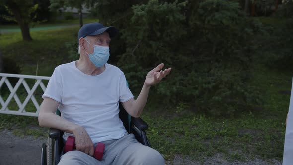 Doctor Supports His Old Man in Wheelchair alt