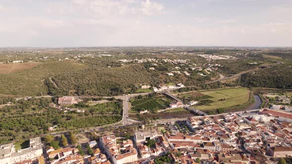 Aerial wide fly-over Algarve Castle of silves from Arade River outskirts alt
