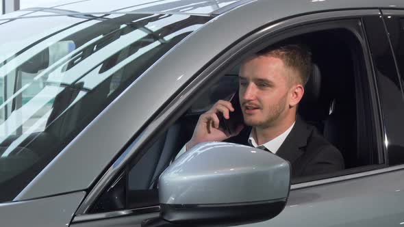 Businessman Talking on the Phone, Sitting in a New Automobile 1080p alt