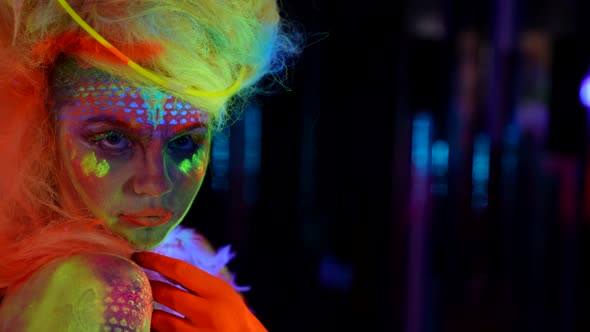Artistic Makeup and Body Art with Fluorescent Paints Female Portrait in Darkness alt