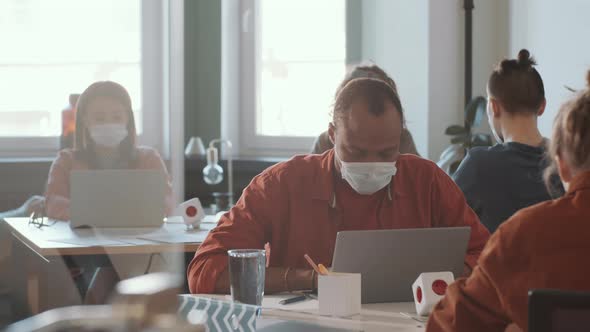 African American Man in Face Mask Working in Open Space Office alt