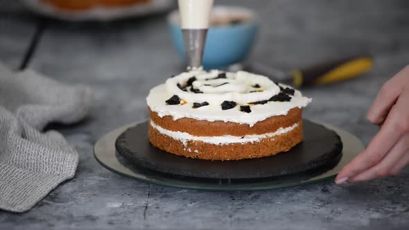 Pastry Chef Makes a Layered Cake with Prune and Whipping Cream