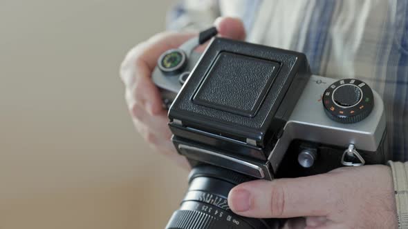 Close-up vintage photo camera details, setting up the film camera. alt