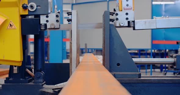 The Blade of a Metal Cutting Machine Is Lowering To Cut the Big Metal Piece  alt