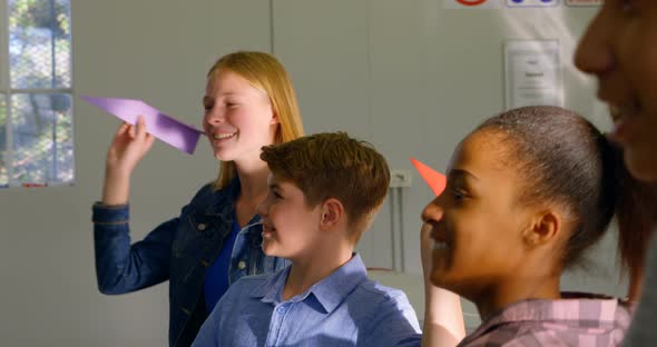 Kids throwing paper plane in training institute 4k alt