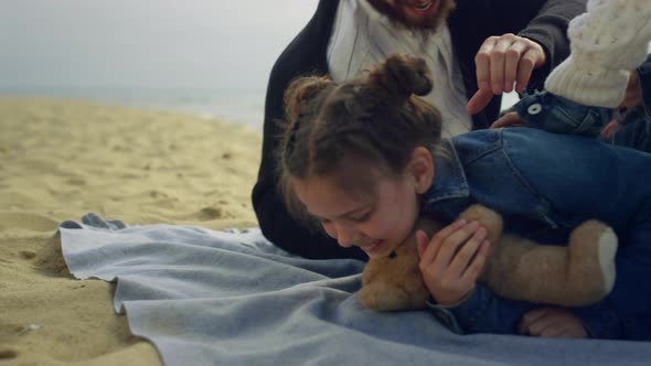 Laughing Girl Playing Family on Sea Beach Sand alt
