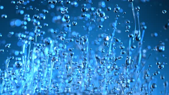 Super Slow Motion Shot of Splashing Blue Liquid on Gradient Background at 1000Fps alt