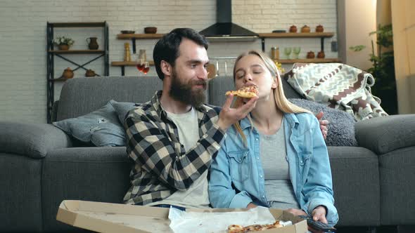 Couple relaxing, watching TV.