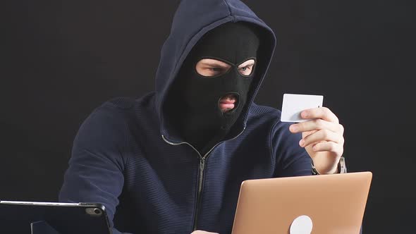 Man Hacking Laptop System Want to Hack Bank Card