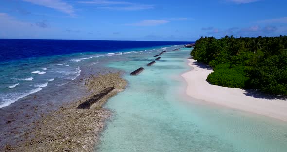 Wide overhead island view of a summer white paradise sand beach and blue water background in colorfu alt