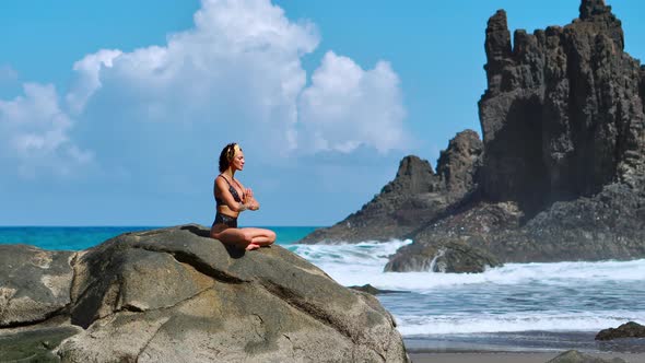 Serene Meditation Yoga. Brunette Tourist Woman Meditating in Lotus Position alt
