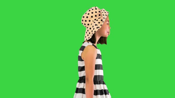 Beautiful Asian Girl in Sundress and a Summer Hat Walking on a Green Screen Chroma Key alt