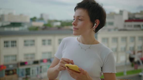 Woman Listens to Music and Dances Against the Background of the Megalopolis alt