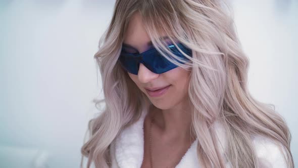 Pretty Lady in Bathrobe Undergoing Laser Epilation in Clinic alt