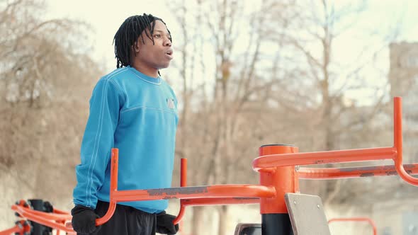 African American Man Footballer Warming Up on Sports Ground alt