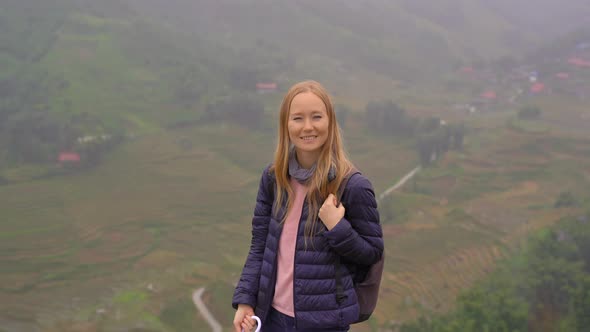 A Young Woman Traveler Enjoys Her Time in a Cat Cat Valley alt