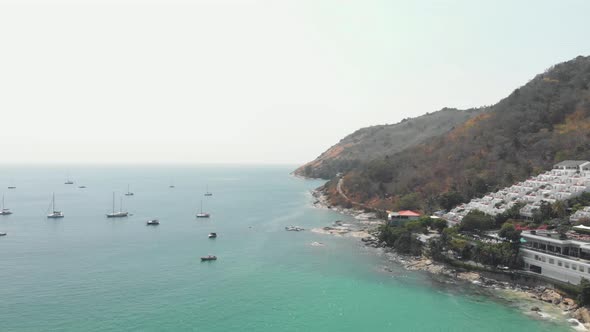 Boats at sea off Phuket Island. Amazing hotel resort on the tropical coastline alt